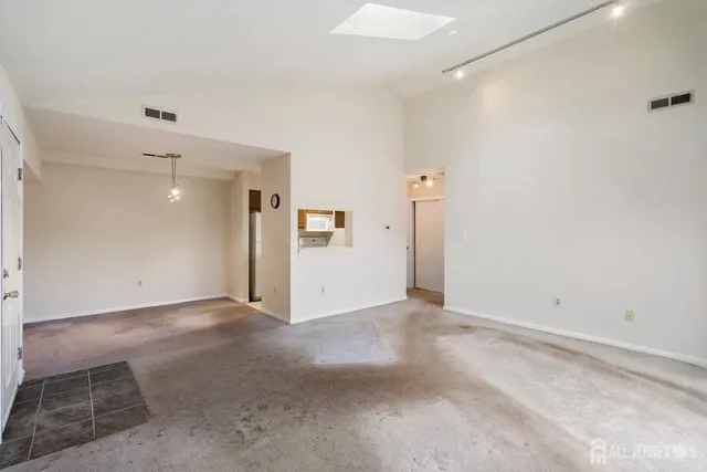 a view of a refrigerator in kitchen and white wall