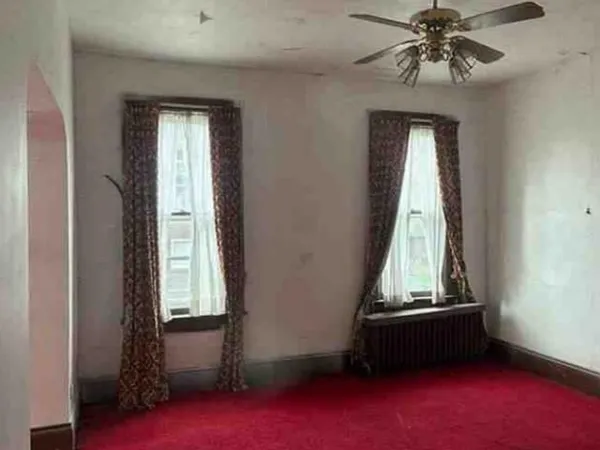a living room with a window and a chandelier