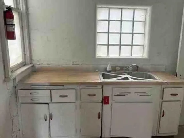 a utility room with cabinets washer and dryer