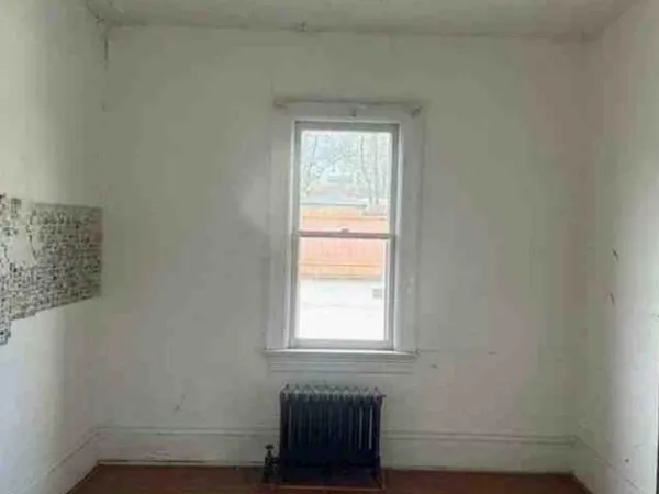 a bathroom with a window and a shower