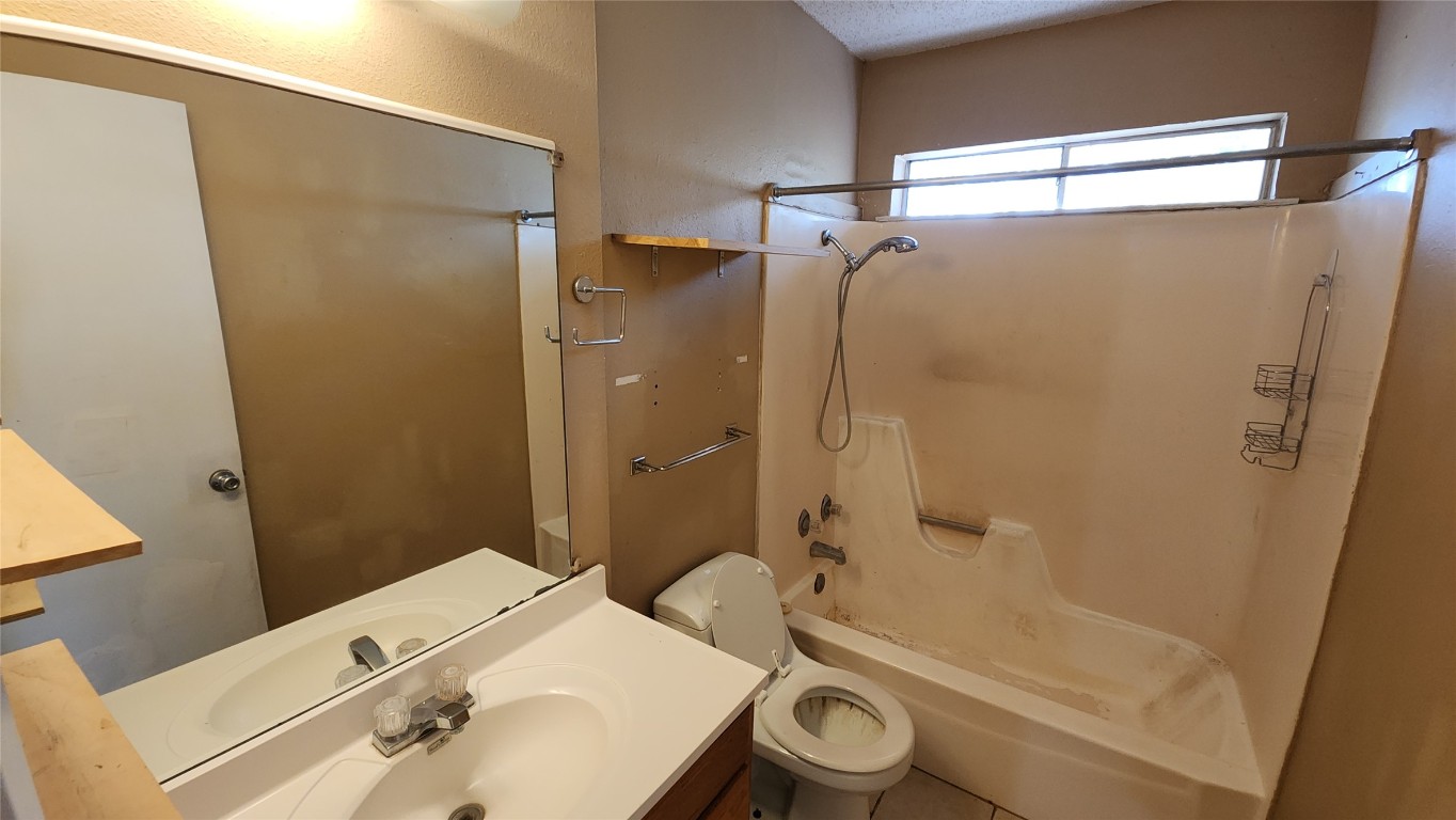 208 Vanderveer, Unit 4 Burnet, TX 78611 - Photo 13 of 13 a bathroom with a sink a toilet and shower