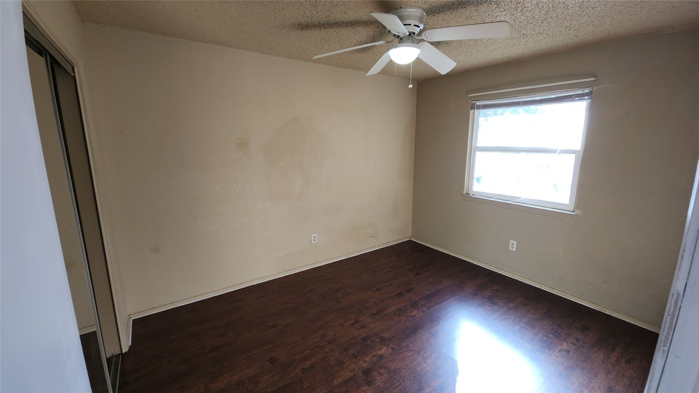 208 Vanderveer, Unit 4 Burnet, TX 78611 - Photo 10 of 13 an empty room with wooden floor fan and windows
