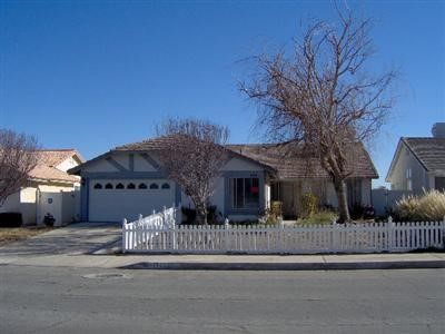 12805 Pacoima Road Victorville, CA 92392 - Photo 1 of 1 a view of a brick house with a large windows