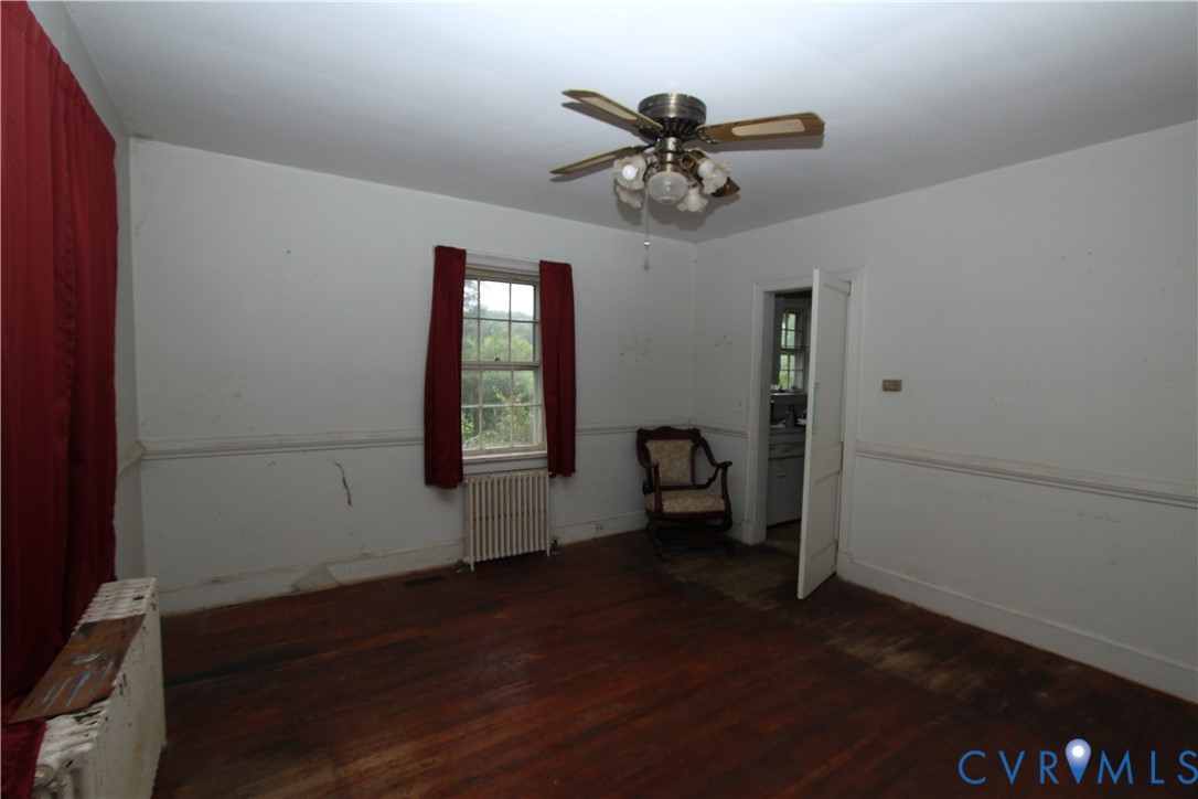 17037 Beaver Dam Road Beaverdam, VA 23015 - Photo 2 of 27 a view of a livingroom with a chair and wooden floor