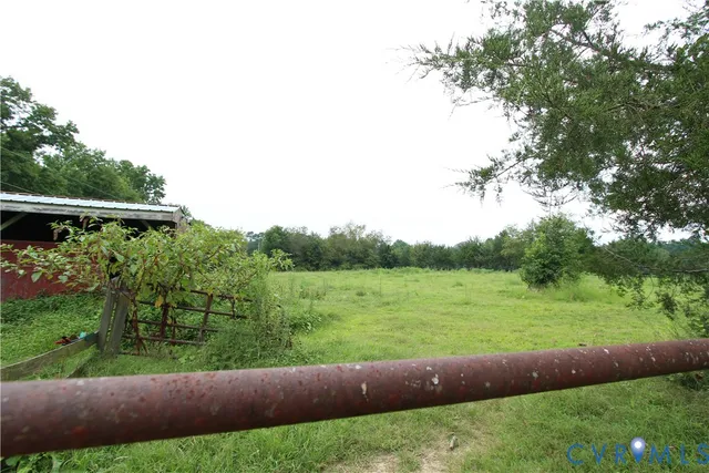 a view of a field with grass and a small yard