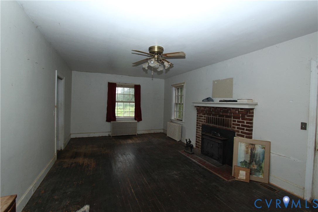 17037 Beaver Dam Road Beaverdam, VA 23015 - Photo 5 of 27 a view of a livingroom with a fireplace and a chandelier fan