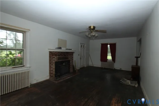 wooden floor in an empty room with a fireplace