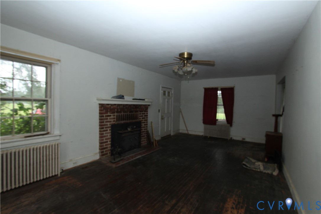 17037 Beaver Dam Road Beaverdam, VA 23015 - Photo 6 of 27 wooden floor in an empty room with a fireplace