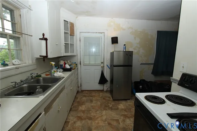 a kitchen with a sink and refrigerator
