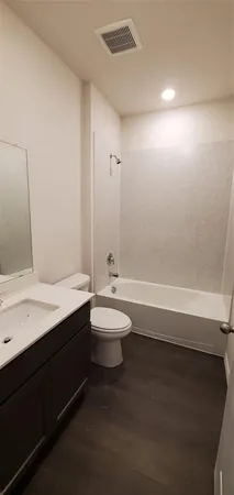 a bathroom with a double vanity sink toilet and shower