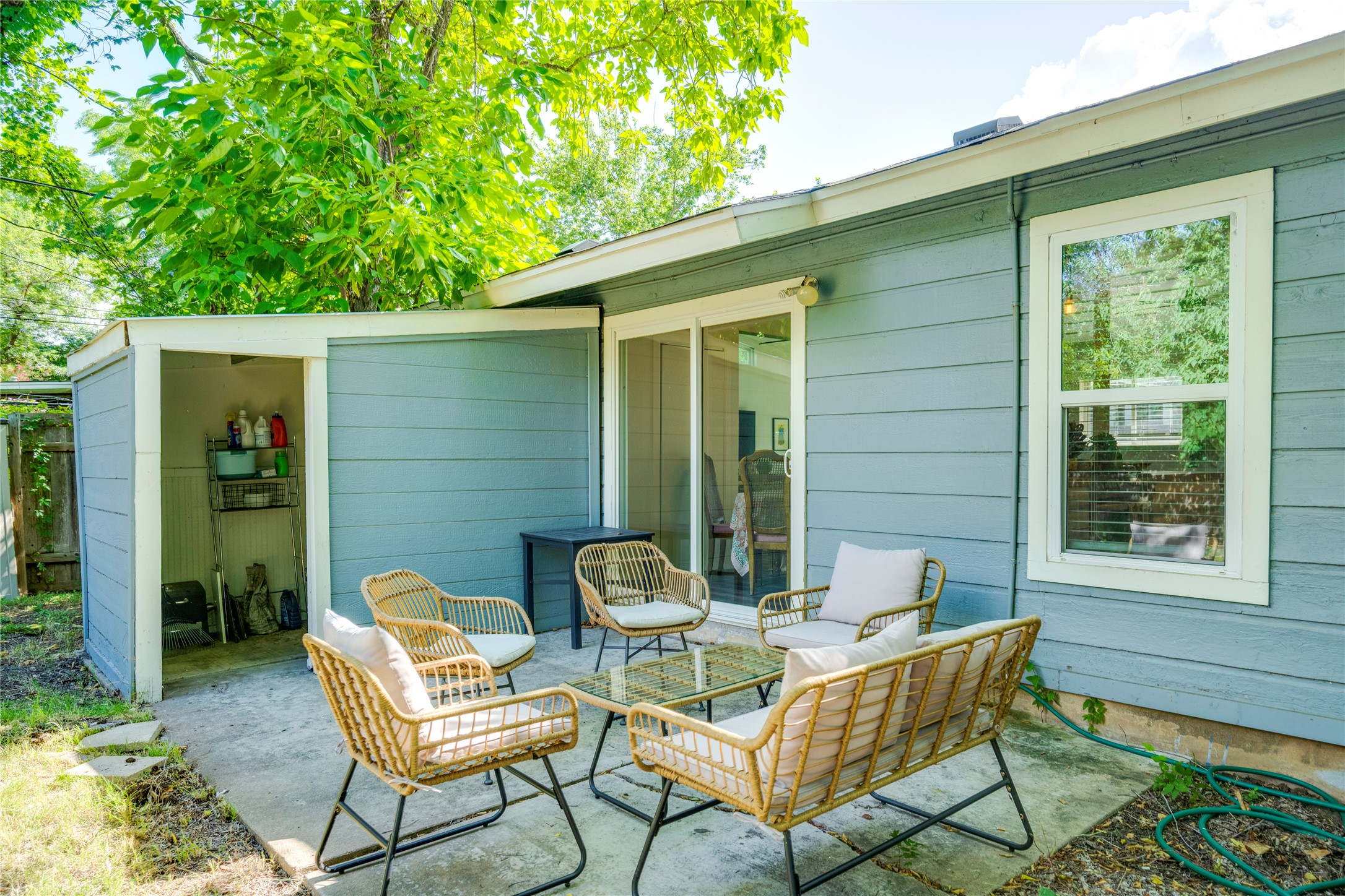 5300 Halmark Drive Austin, TX 78723 - Photo 37 of 40 An inviting outdoor patio, perfect for enjoying quiet afternoons, features comfortable seating and easy access to a convenient storage shed.
