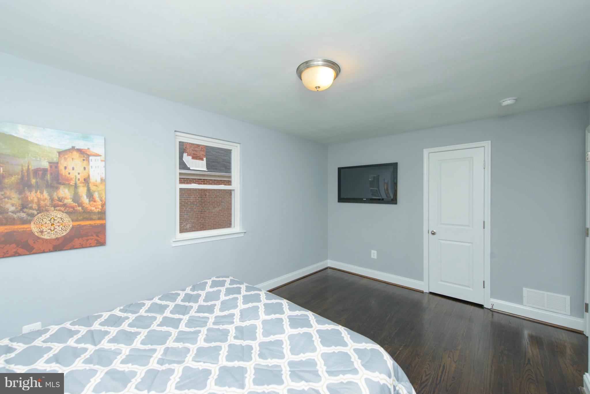 2127 Firethorn Road Baltimore, MD 21220 - Photo 13 of 30 a bedroom with a bed and a lamp on the table