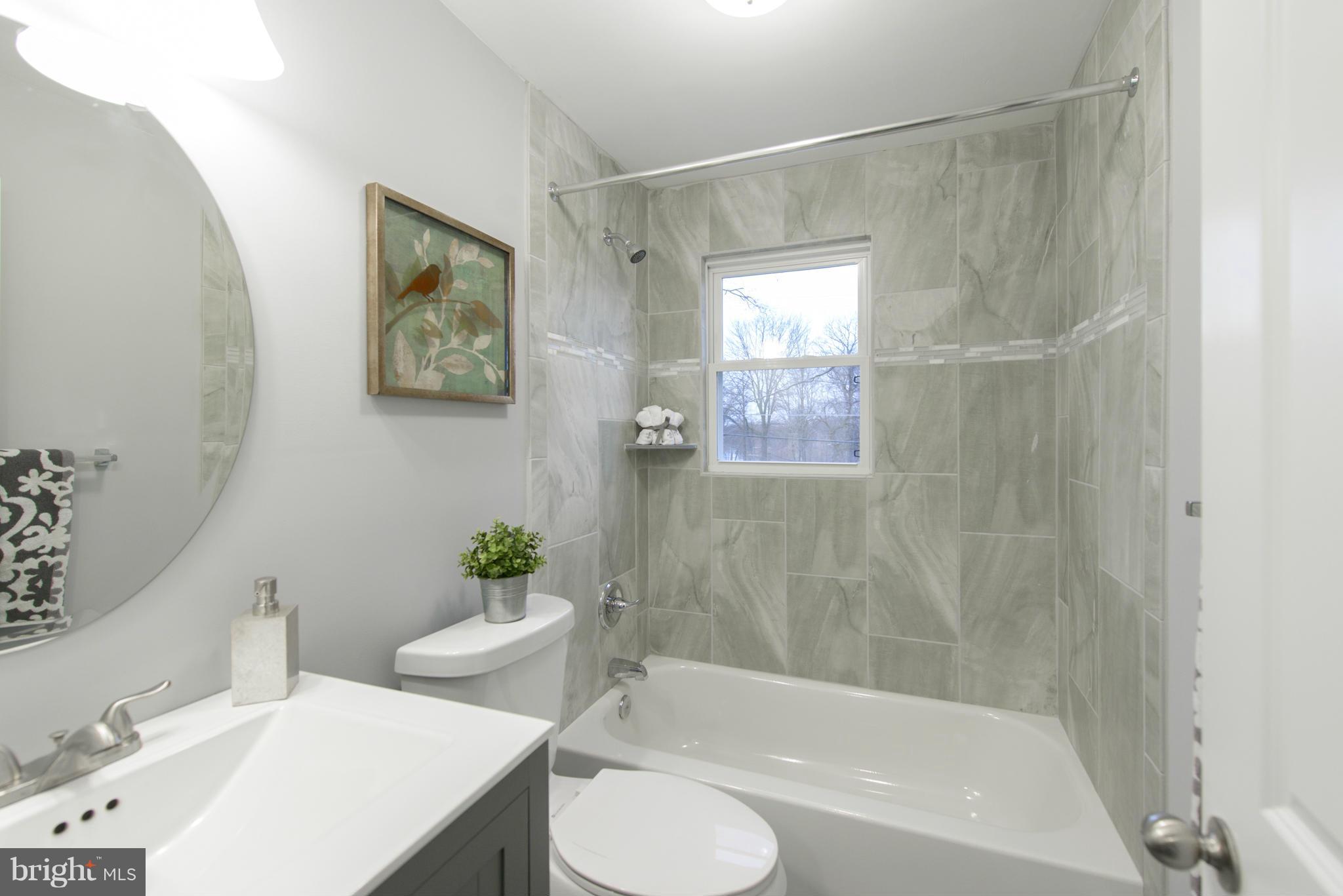 2127 Firethorn Road Baltimore, MD 21220 - Photo 14 of 30 a bathroom with a sink and a bathtub