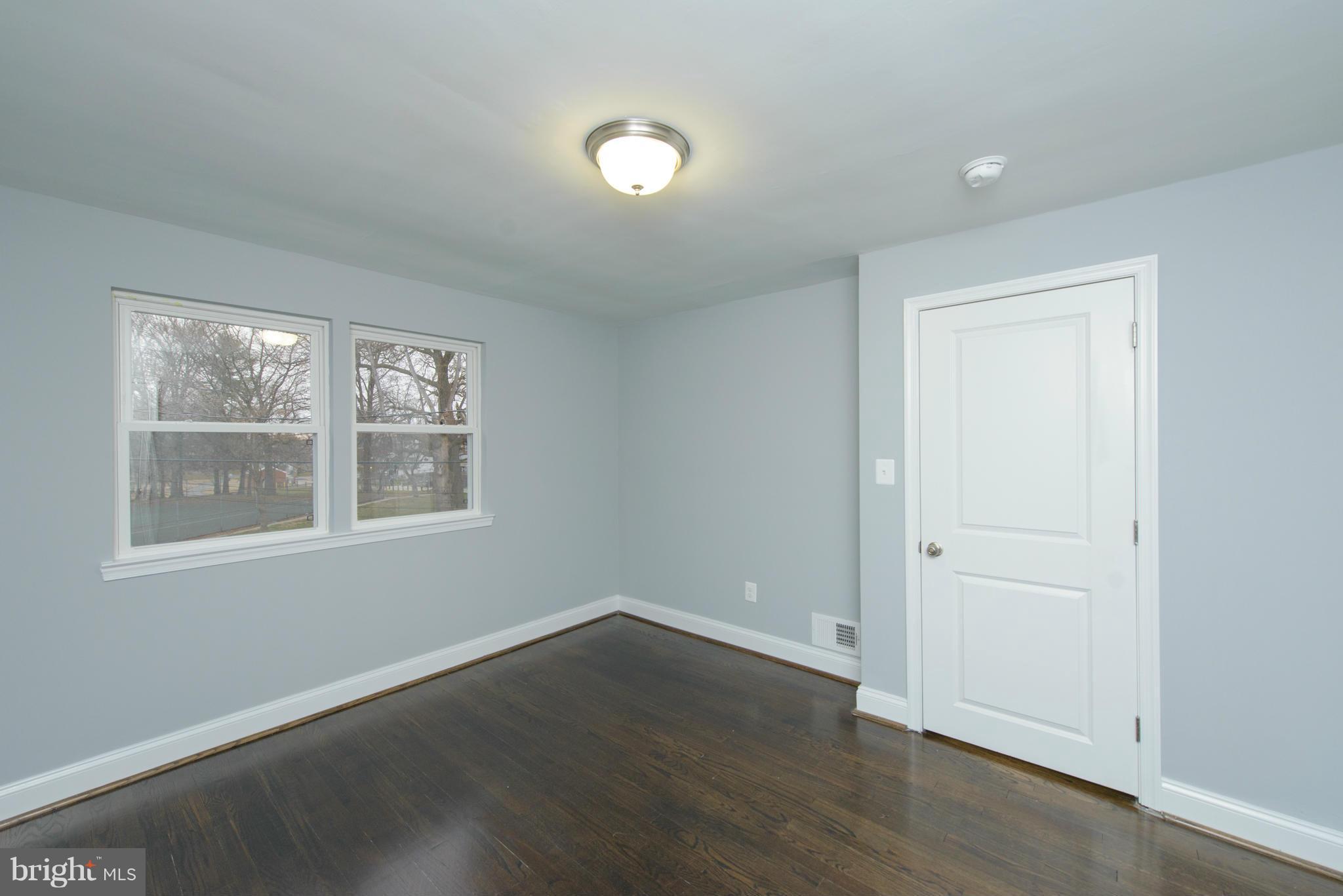 2127 Firethorn Road Baltimore, MD 21220 - Photo 17 of 30 an empty room with wooden floor and windows