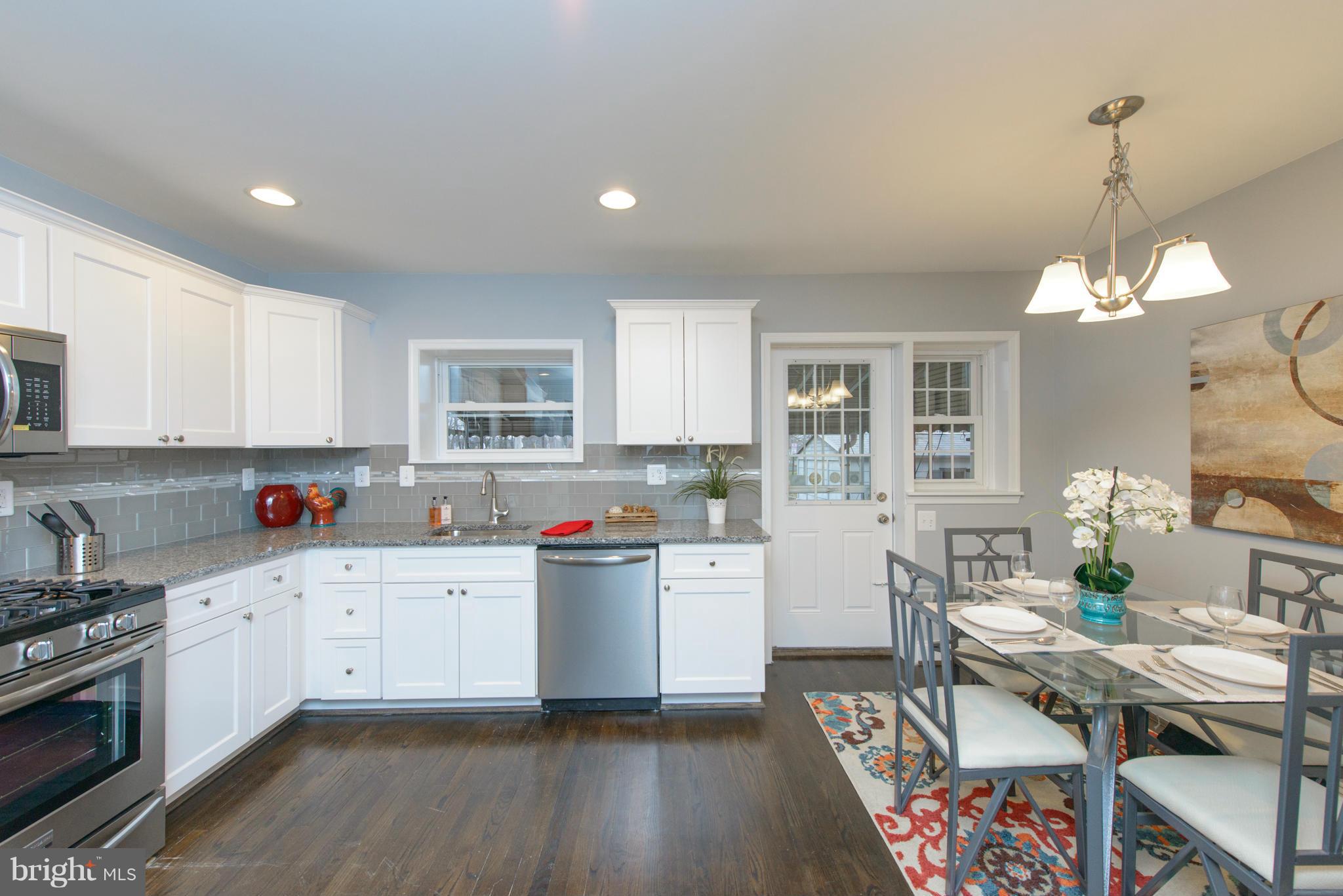 2127 Firethorn Road Baltimore, MD 21220 - Photo 8 of 30 a open kitchen with stainless steel appliances granite countertop a stove and white cabinets
