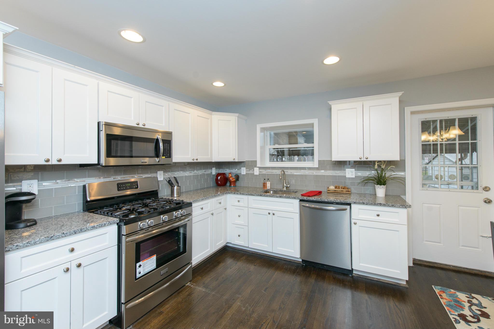 2127 Firethorn Road Baltimore, MD 21220 - Photo 9 of 30 a kitchen with granite countertop white cabinets and white appliances
