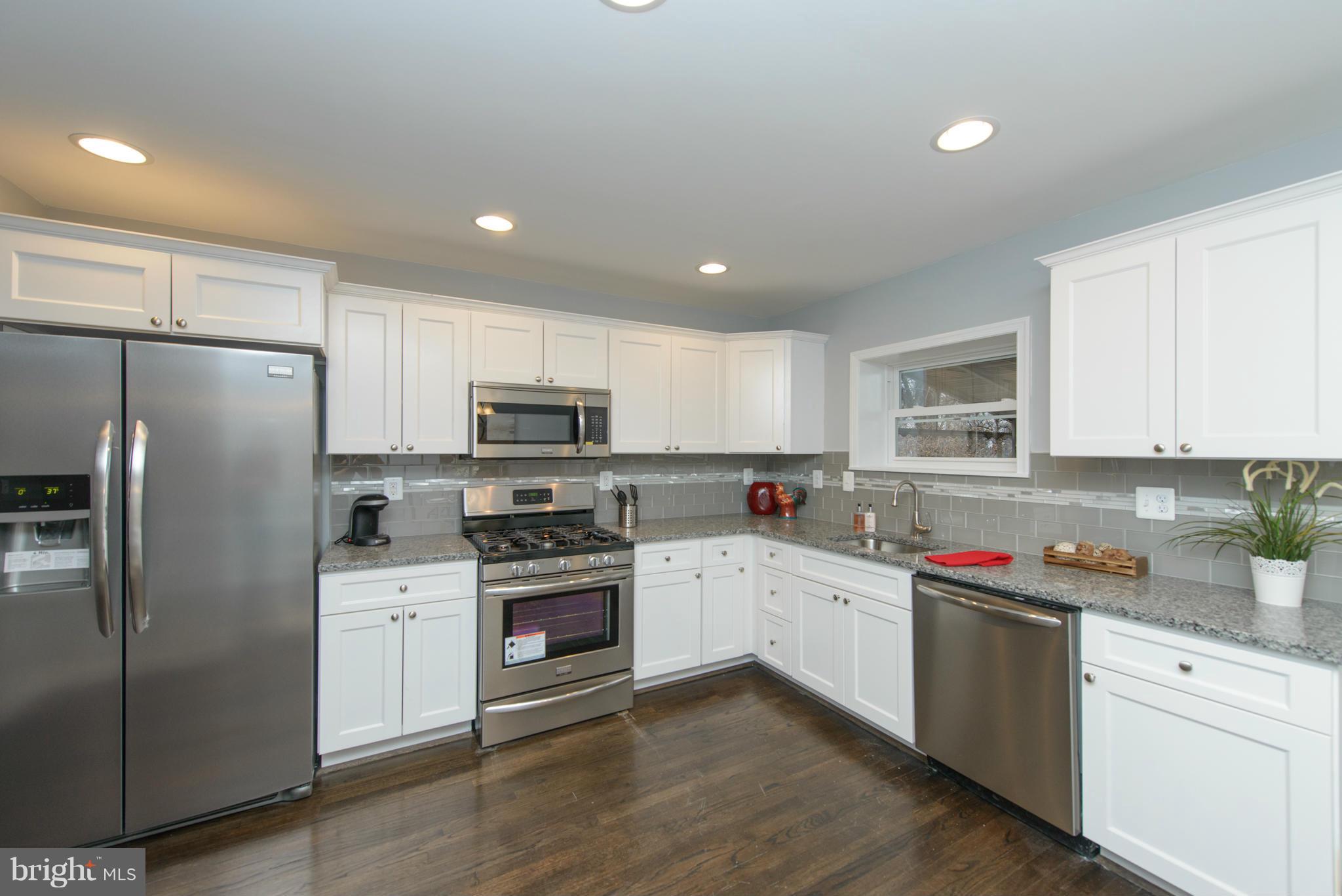 2127 Firethorn Road Baltimore, MD 21220 - Photo 10 of 30 a kitchen with stainless steel appliances granite countertop a refrigerator sink and stove
