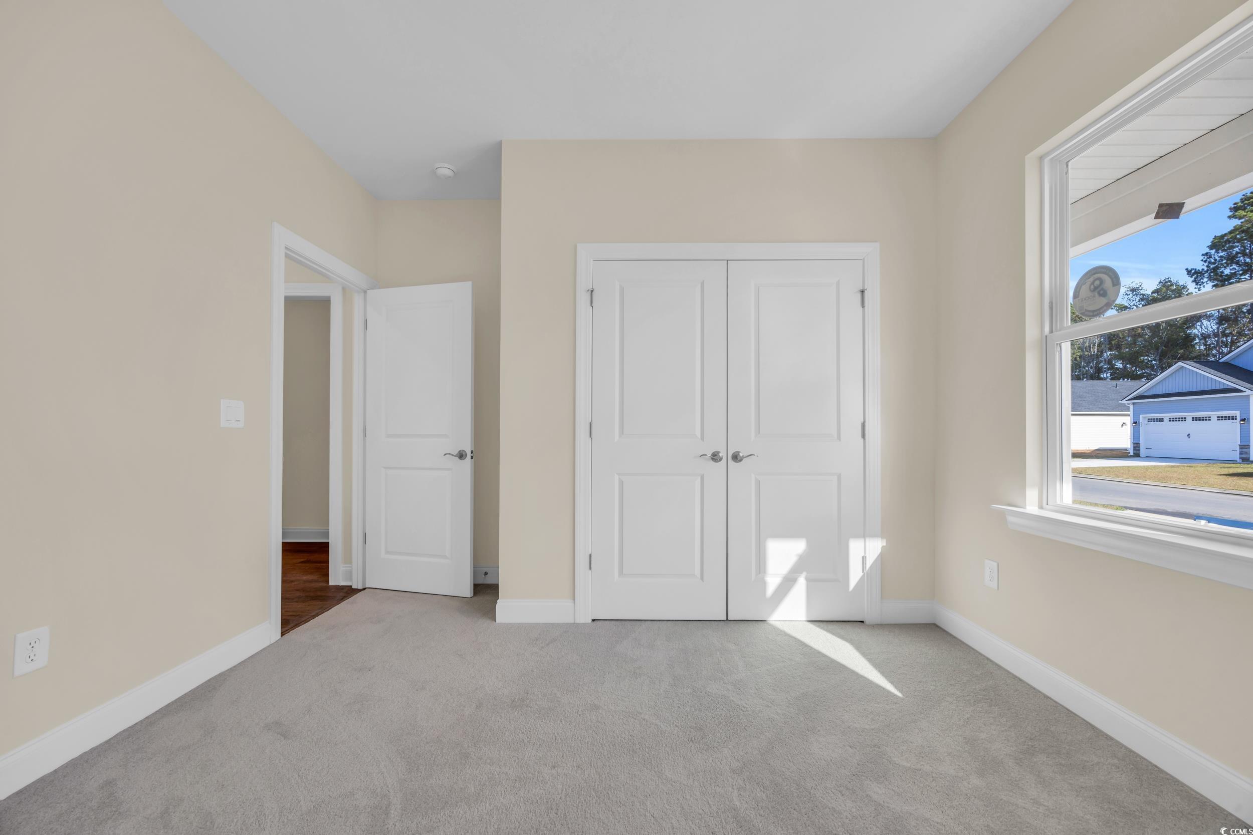 547 Beckham Court Murrells Inlet, SC 29576 - Photo 11 of 40 Unfurnished bedroom with light carpet and a closet