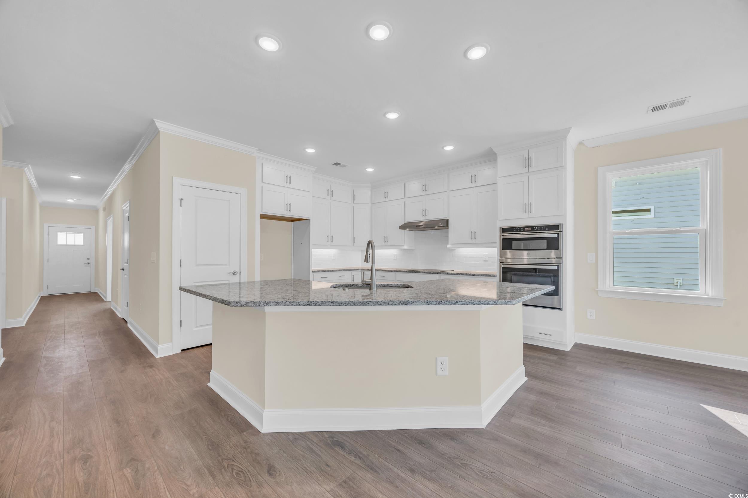 547 Beckham Court Murrells Inlet, SC 29576 - Photo 2 of 40 Kitchen with white cabinets, a center island with