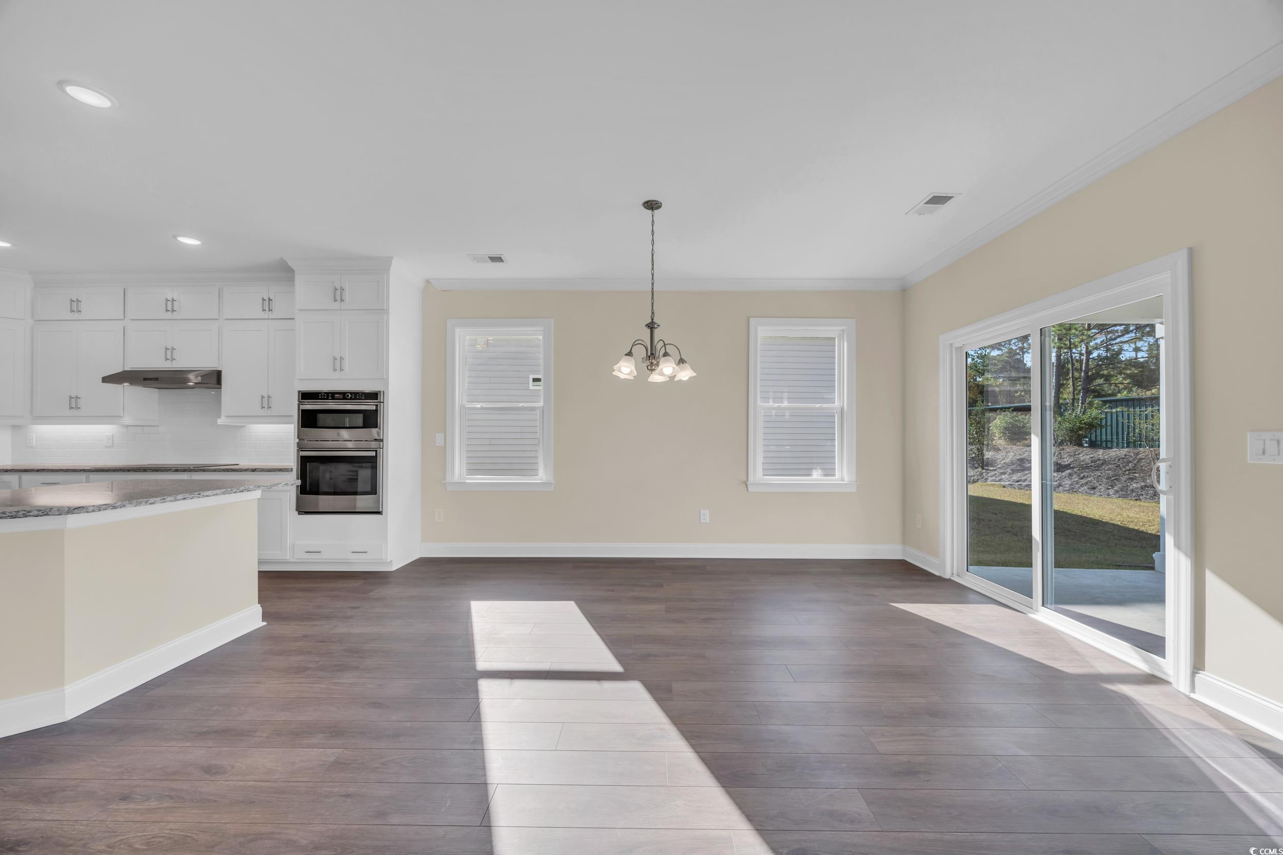 547 Beckham Court Murrells Inlet, SC 29576 - Photo 9 of 40 Kitchen featuring white cabinetry, a chandelier, d