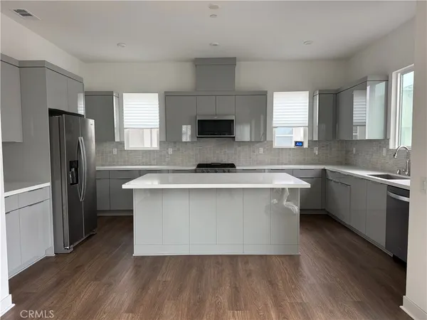 a kitchen with a refrigerator and a sink
