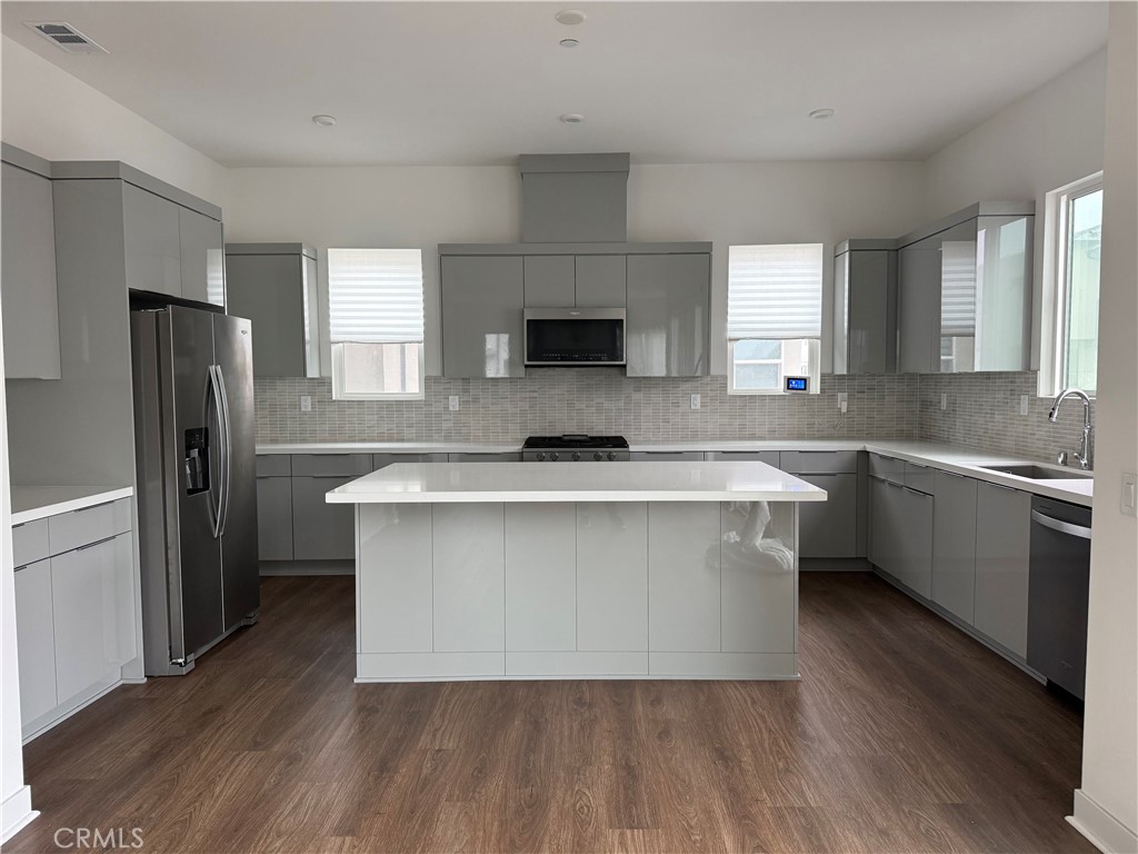 1402 West Bushell Street Anaheim, CA 92805 - Photo 2 of 10 a kitchen with a refrigerator and a sink