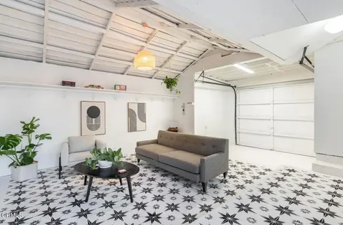 a living room with furniture and flowers