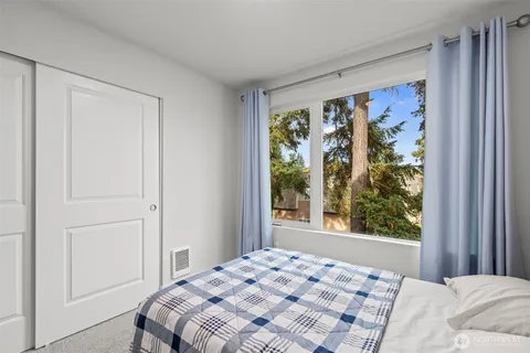 a bathroom with a granite countertop sink a toilet and a bathtub