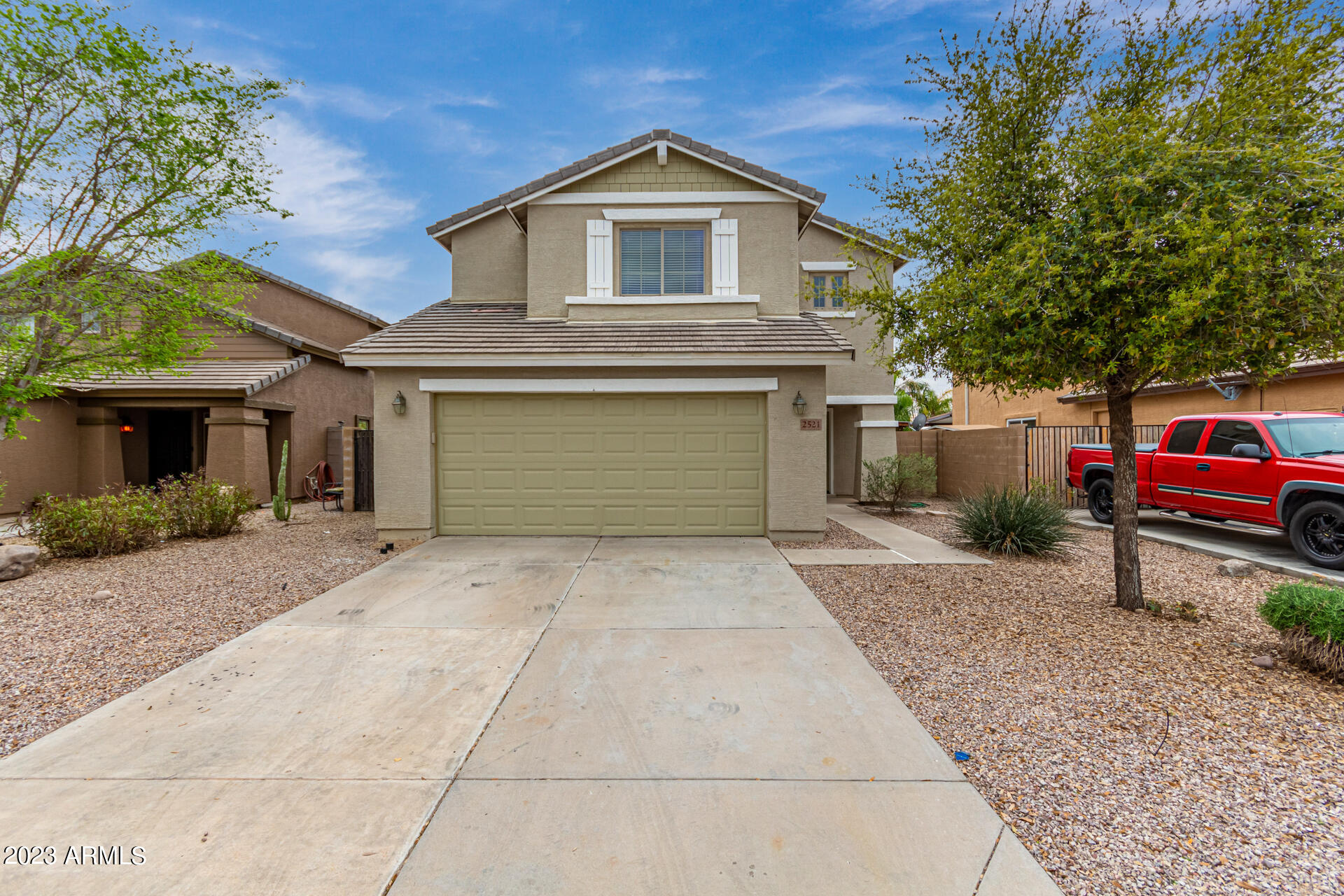 2521 West Desert Spring Way Queen Creek, AZ 85144 - Photo 2 of 39 a front view of a house with garage