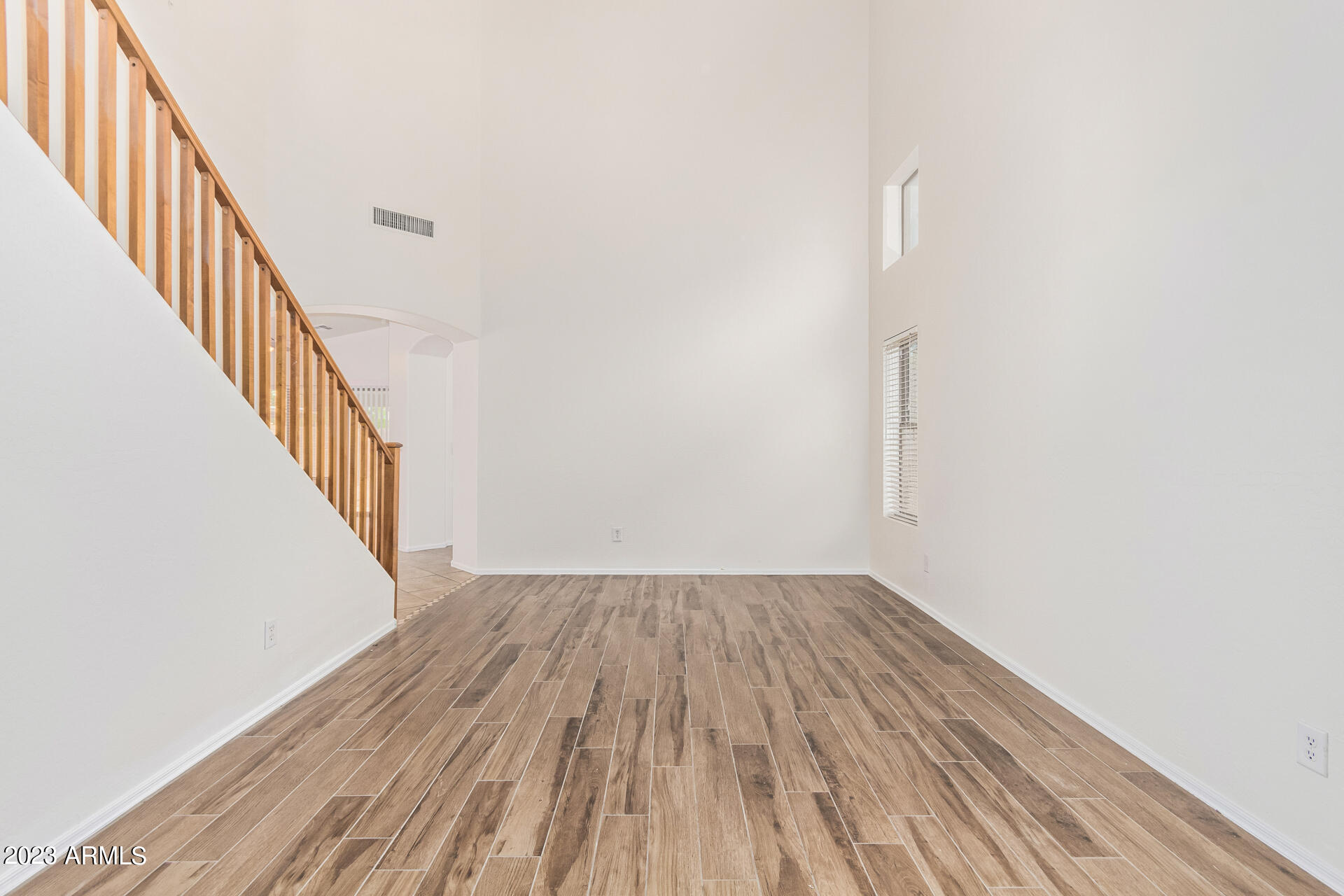 2521 West Desert Spring Way Queen Creek, AZ 85144 - Photo 9 of 39 a view of a hallway with wooden floor