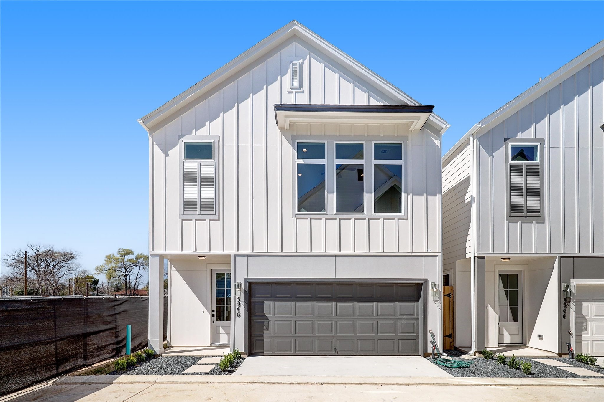 a front view of a house with wooden fence