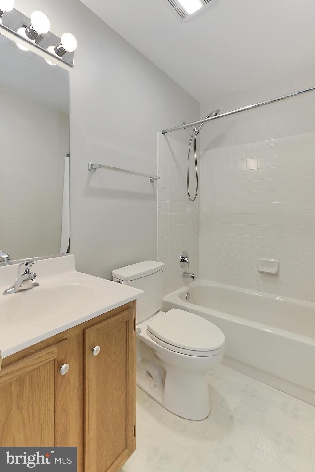 7005 E Birkenhead Place, Unit E Alexandria, VA 22315 - Photo 14 of 21 a bathroom with a granite countertop sink toilet and shower