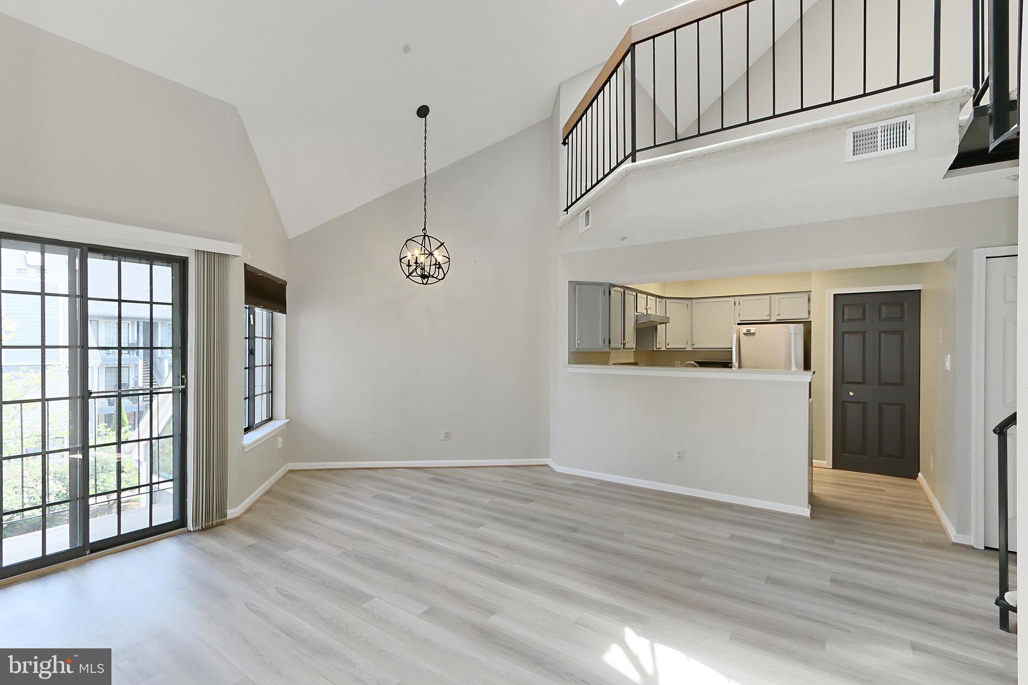 7005 E Birkenhead Place, Unit E Alexandria, VA 22315 - Photo 3 of 21 a view of a big room with wooden floor and windows