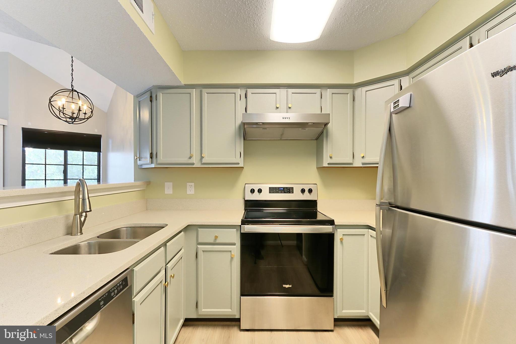 7005 E Birkenhead Place, Unit E Alexandria, VA 22315 - Photo 6 of 21 a kitchen with a refrigerator and a sink