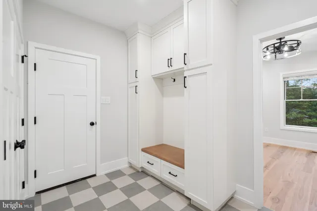 a room with a baby crib and a window