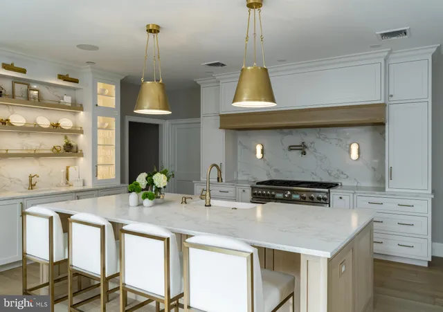 a kitchen with stainless steel appliances a sink a stove and a wooden floor