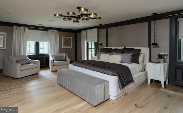 a bedroom with a large bed couch and a window