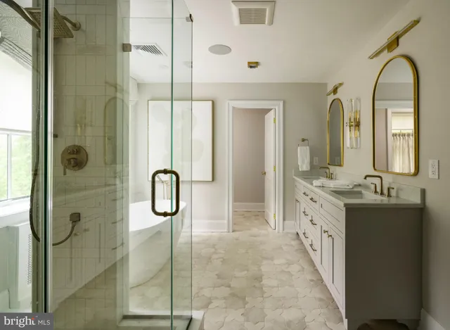 a bathroom with a double vanity sink mirror and shower