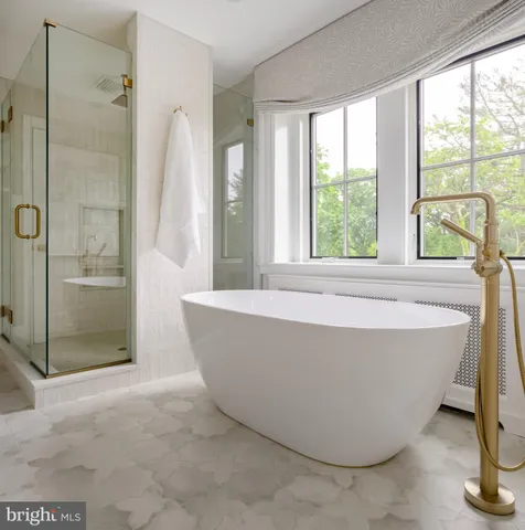 a bathroom with a bathtub and shower