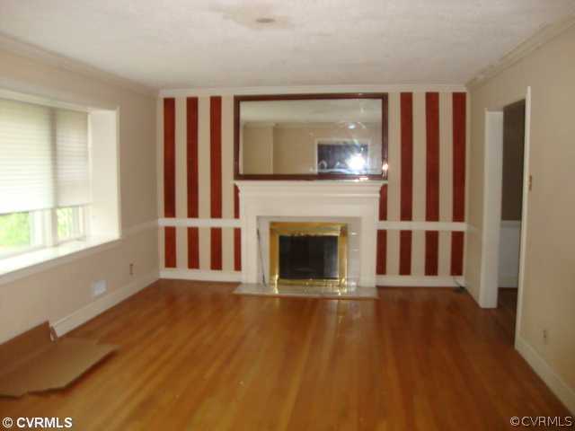 8524 Arran Road Richmond, VA 23235 - Photo 3 of 5 a view of a livingroom with an empty space and a fireplace