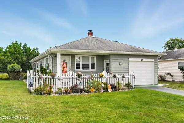 a front view of a house with a garden