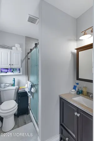 a bathroom with a toilet sink shower and mirror