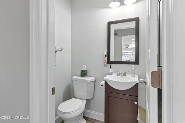 a bathroom with a toilet a sink and mirror