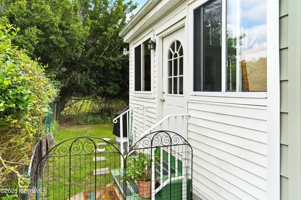 a view of a house with backyard and deck