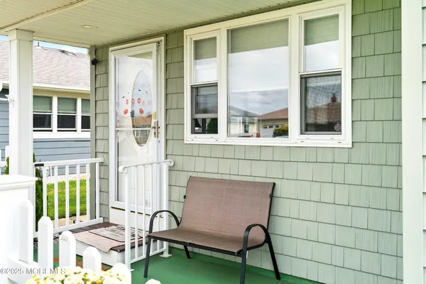 a view of a brick house with a chairs and table in a patio