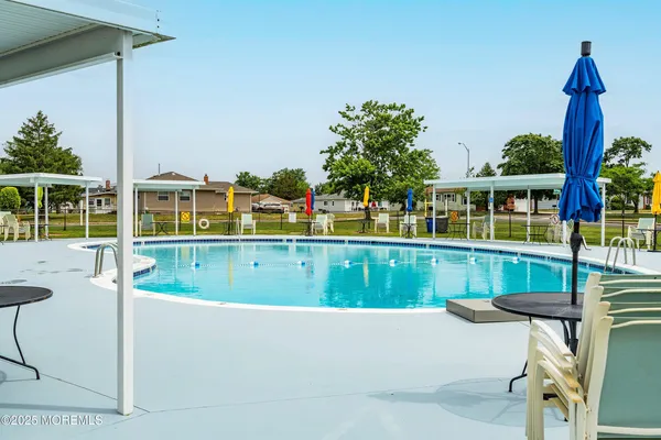 a view of a swimming pool with a lounge chairs