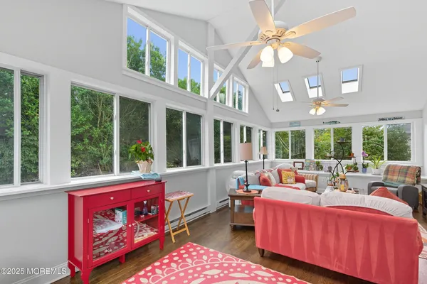 a living room with furniture a large window and a fireplace