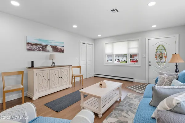 a living room with furniture and a baby crib