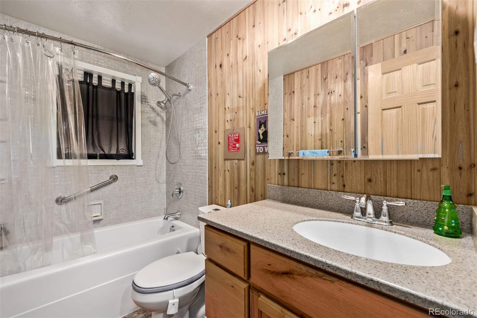 8227 Depew Way Arvada, CO 80003 - Photo 17 of 31 a bathroom with a granite countertop sink a toilet and shower