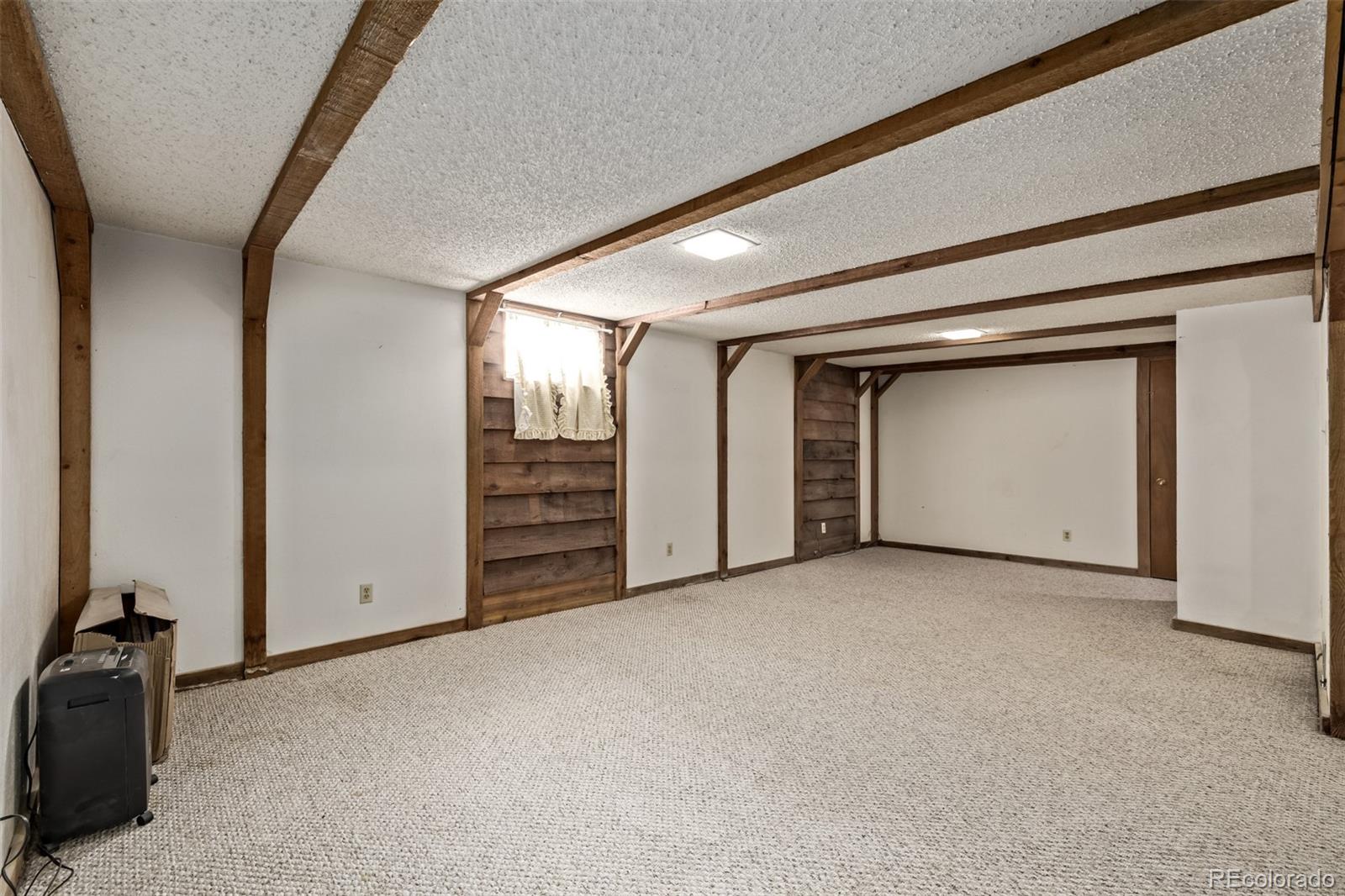 8227 Depew Way Arvada, CO 80003 - Photo 18 of 31 an empty room with closet and natural light